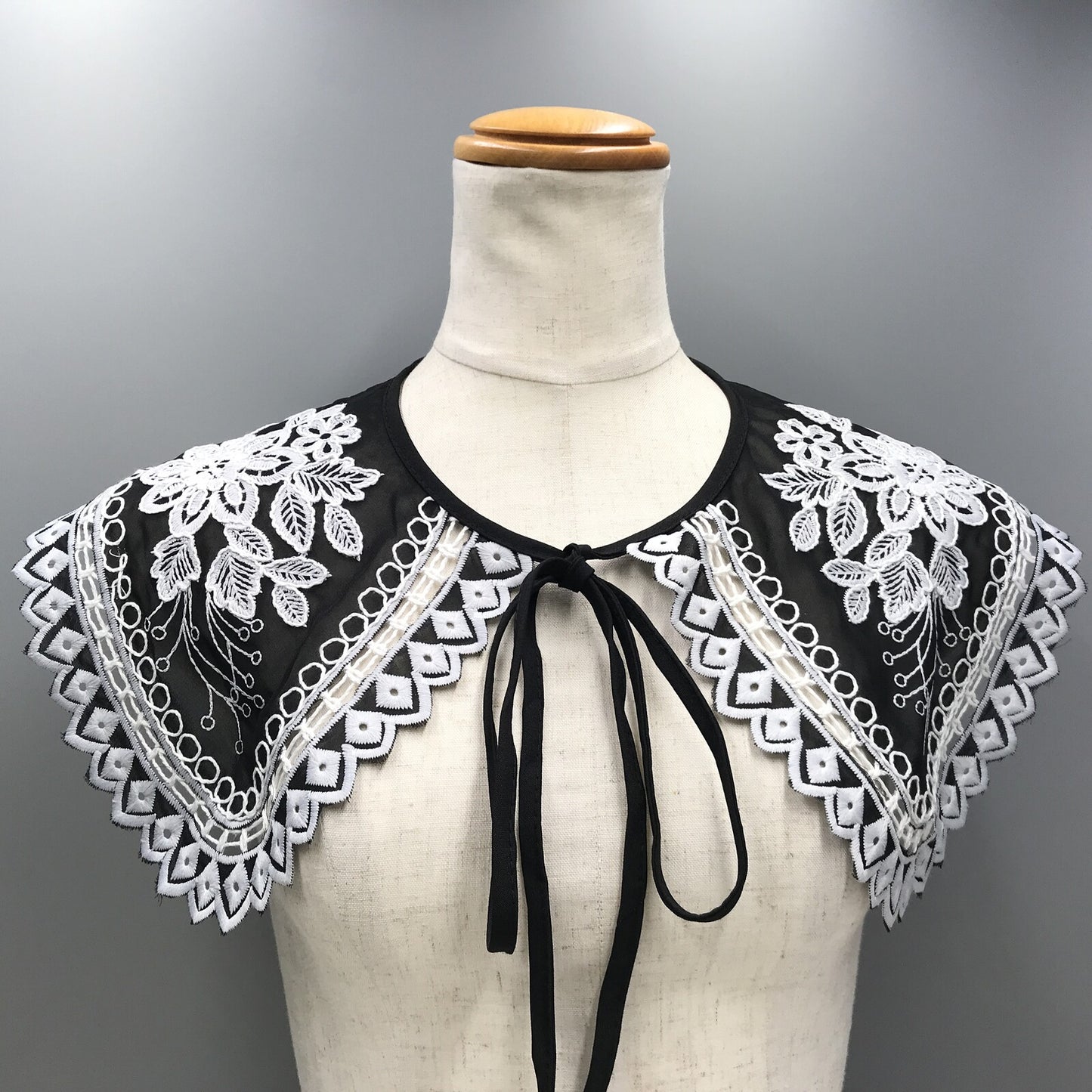 Embroidered black and white shoulder cape