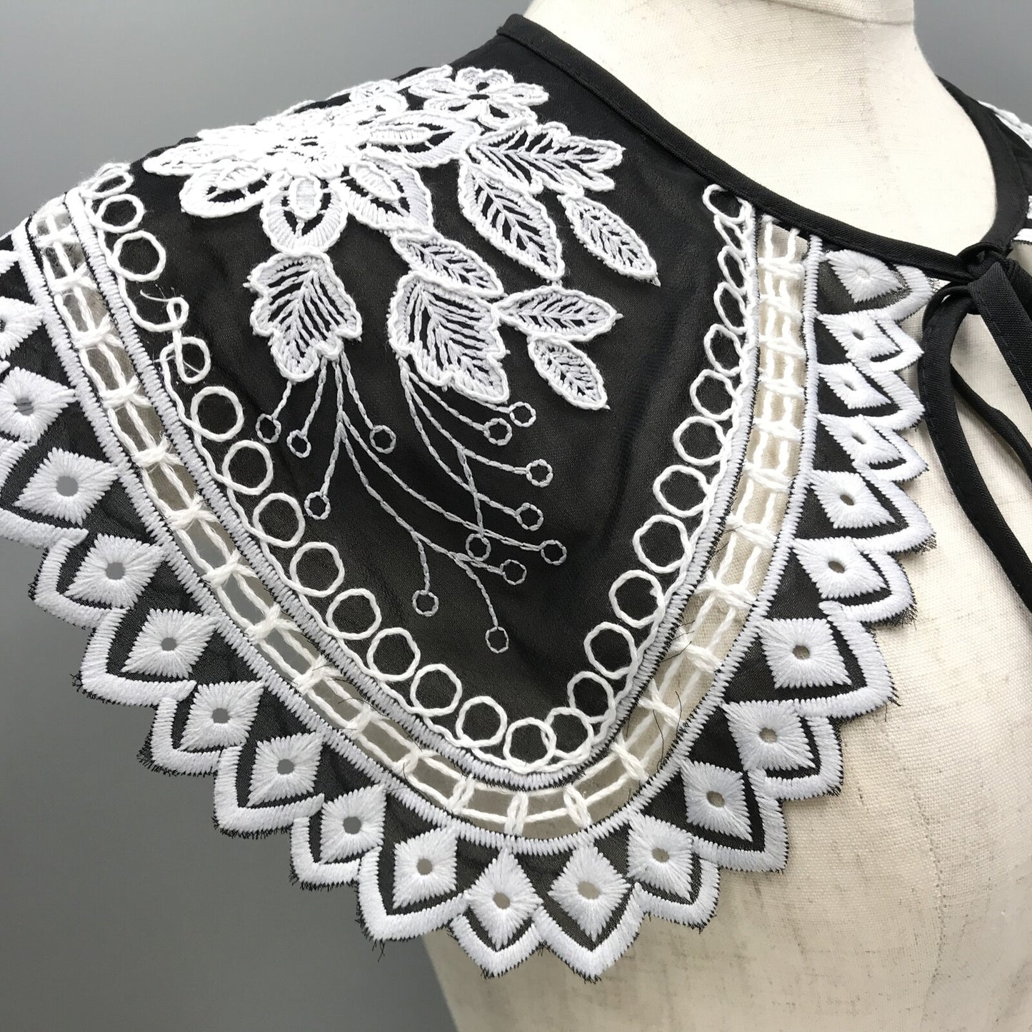 Embroidered black and white shoulder cape